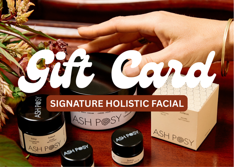 ASH POSY skincare products with a hand holding a gift card on a wooden surface.